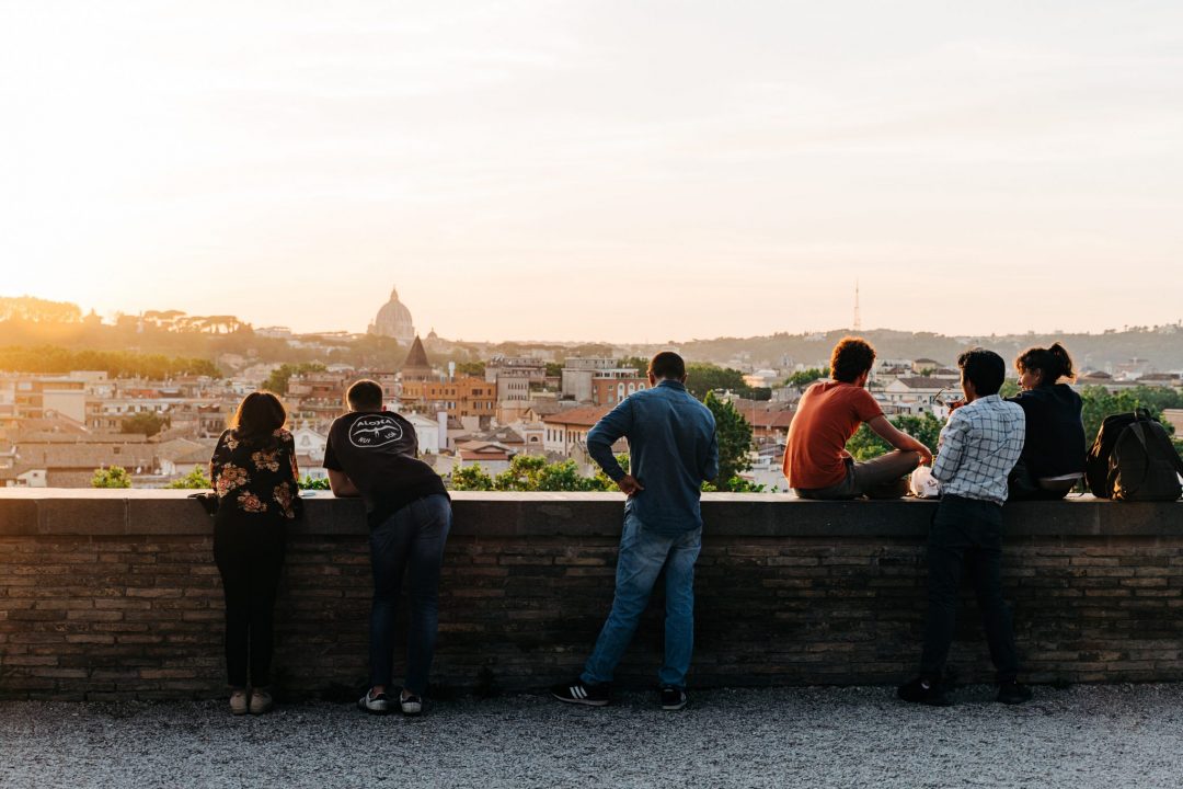 tourists looking over a scene of Rome at sunset