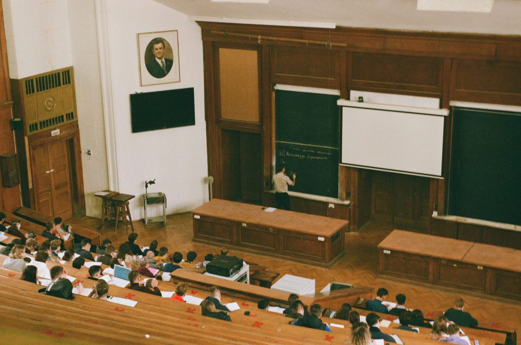 students in a large wooden classroom studying in Italy for Italian student visa