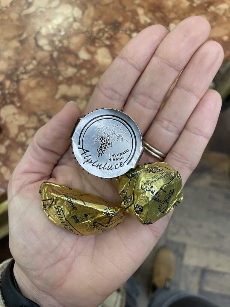 hand holding giordano chocolates including giandiuotto, Giacometti and alpinluce, an assortment of torino chocolate