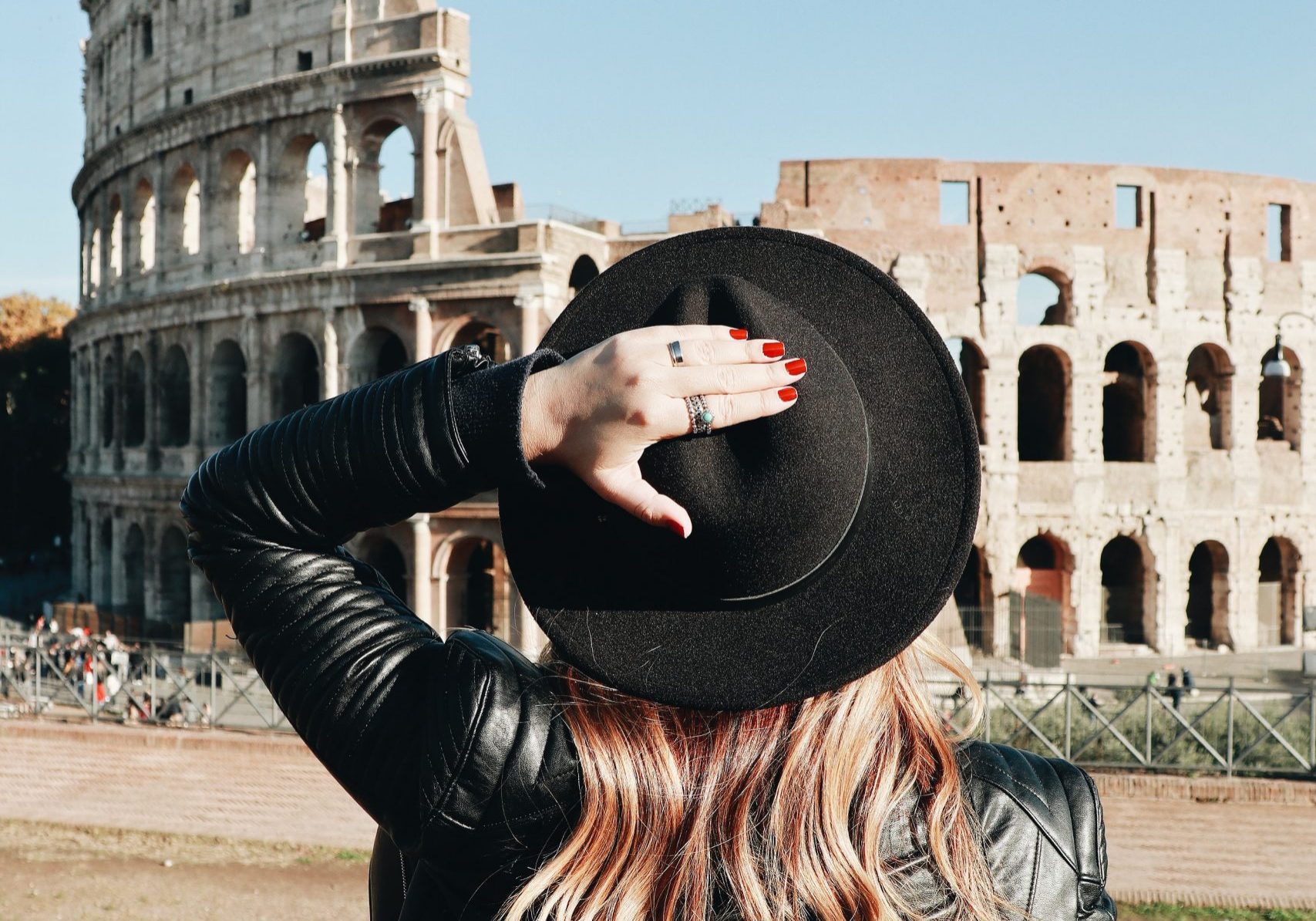 girl looking at the colosseo, thinking about questions to ask moving to italy