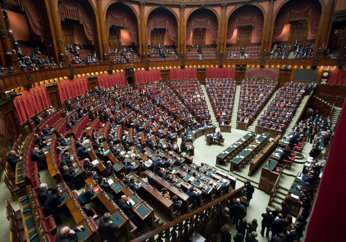 an open room for government meeting in Italy, semi circle with wooden seats, filled with politicians.